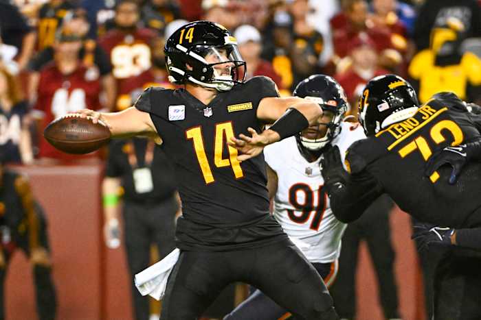Washington Commanders quarterback Sam Howell (14) drops back to pass as Chicago Bears defensive end Yannick Ngakoue (91) rushes during the second half at FedExField.